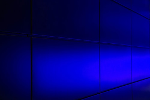 Blue illuminated panels with a smooth gradient, arranged in a grid pattern with visible dark lines separating each panel.