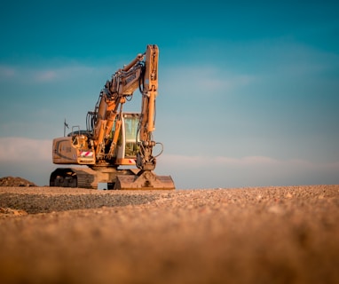 yellow and black excavator on brown sand during daytime