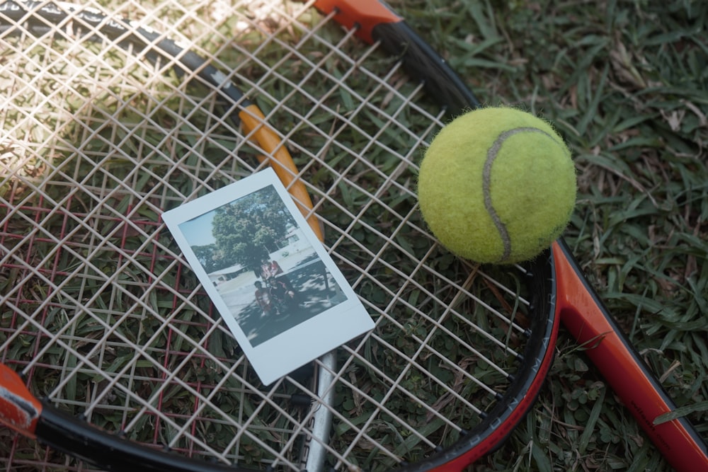 green tennis ball beside white and black card