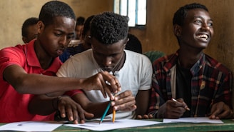 man in gray crew neck shirt holding pen