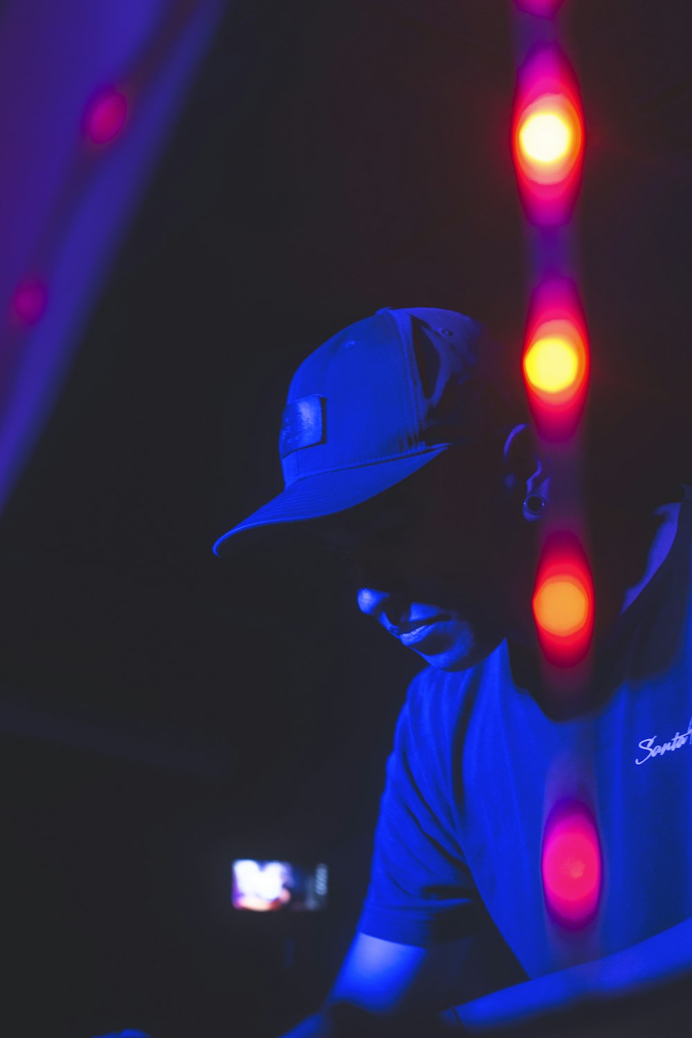 man in black hat and blue and red led lights