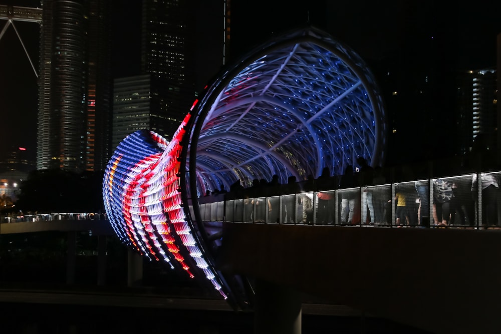 blue and red ferris wheel during night time