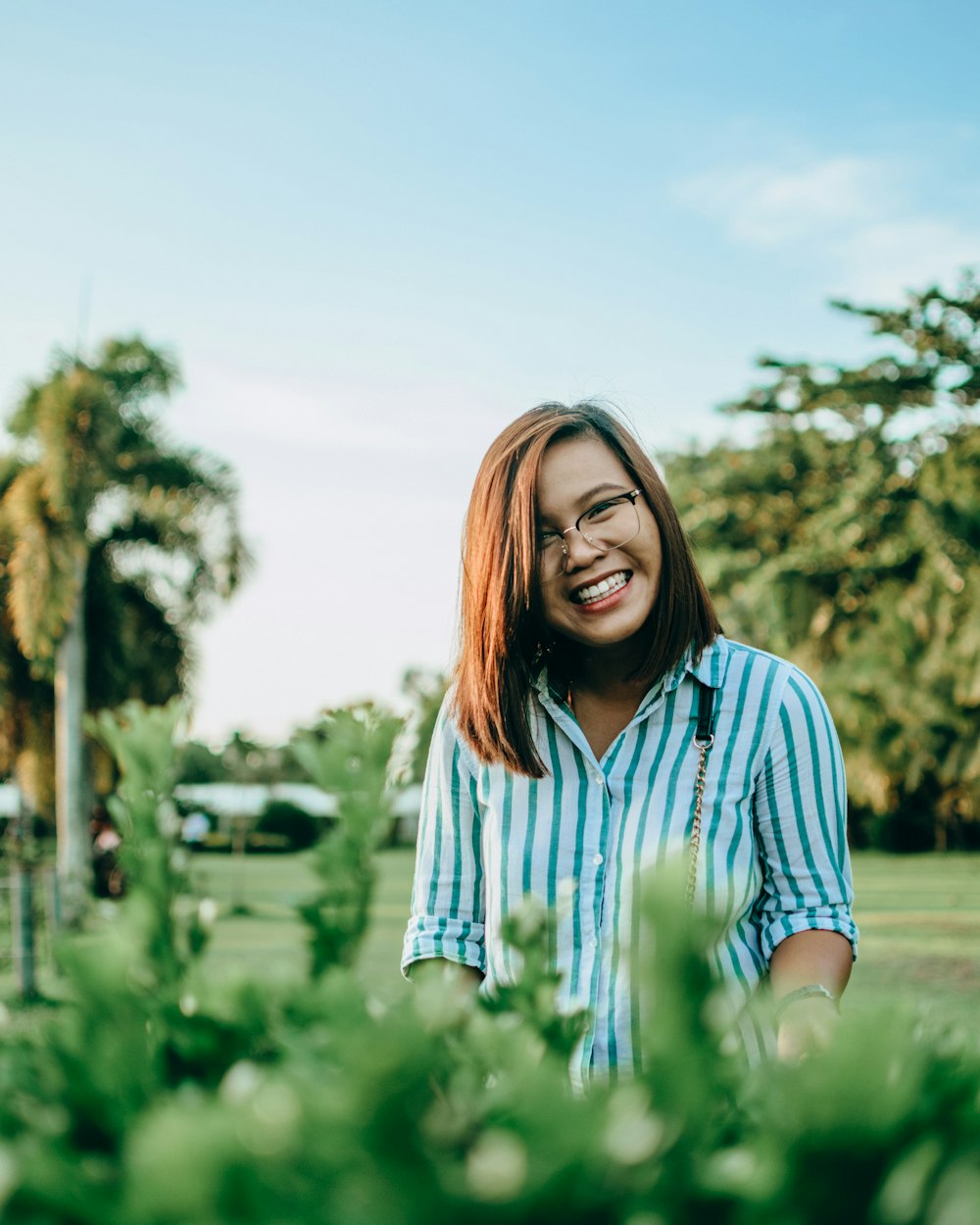 woman in blue and white striped shirt smiling