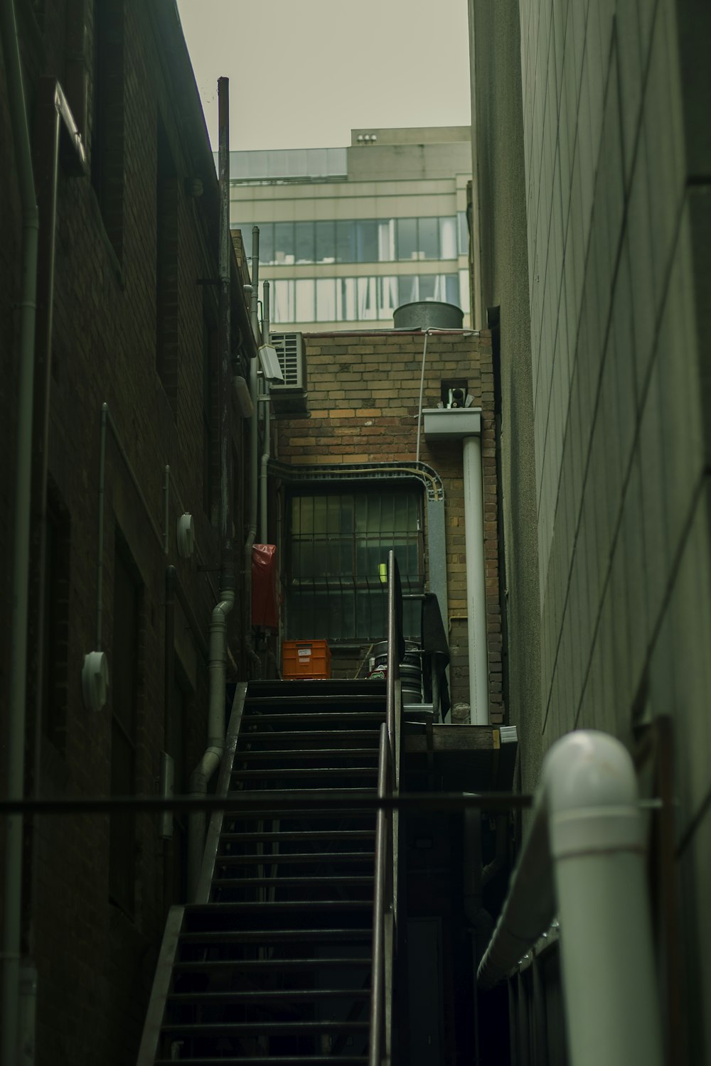 black metal staircase in between buildings