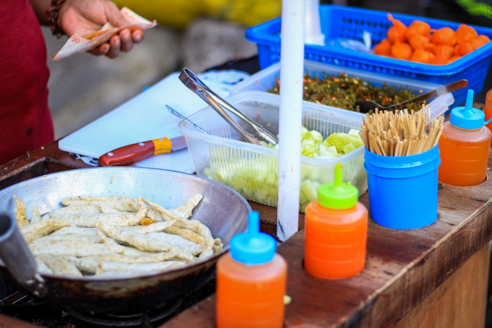 person holding fork and knife slicing food on blue ceramic plate