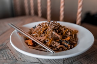 brown and white ceramic bowl with brown and white sticks