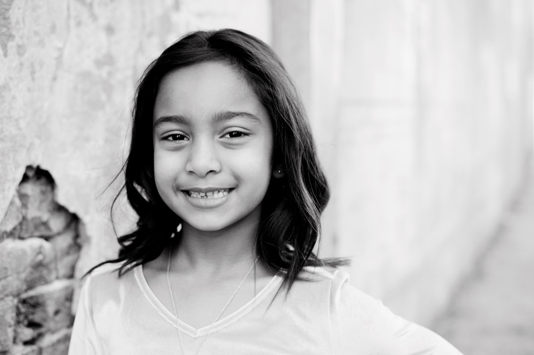 grayscale photo of girl in crew neck shirt