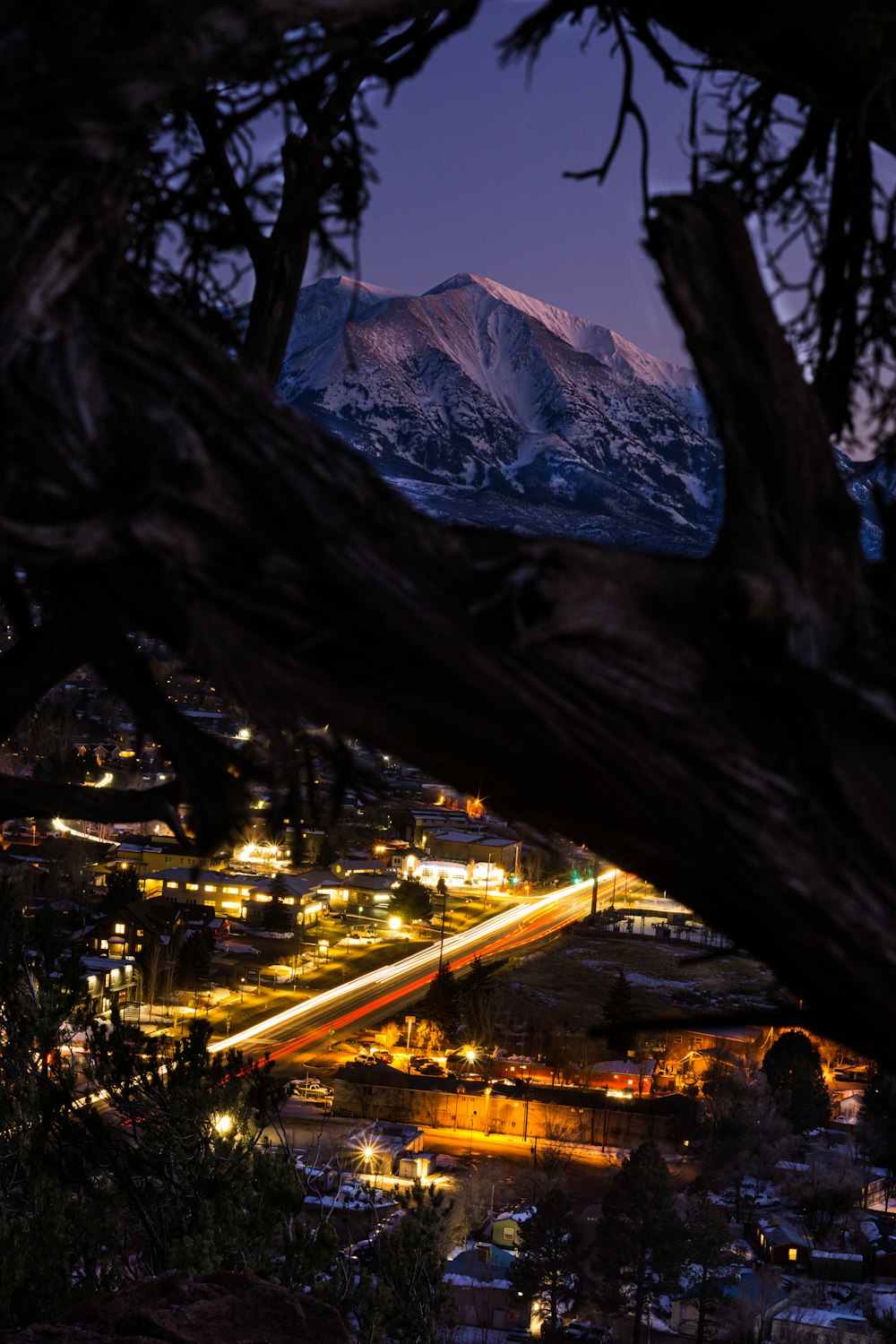 city lights on road near mountain during night time