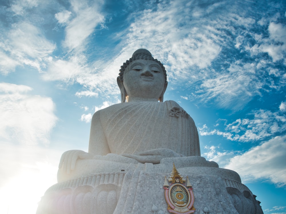 low angle photography of buddha statue under blue sky during daytime