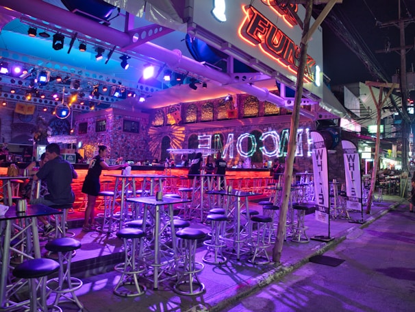 A lively Latin bar atmosphere with colorful decor and happy patrons.