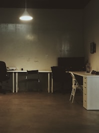 black and gray chair beside white table