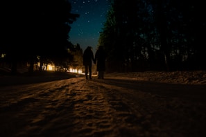 Hands intertwined during a romantic evening walk.