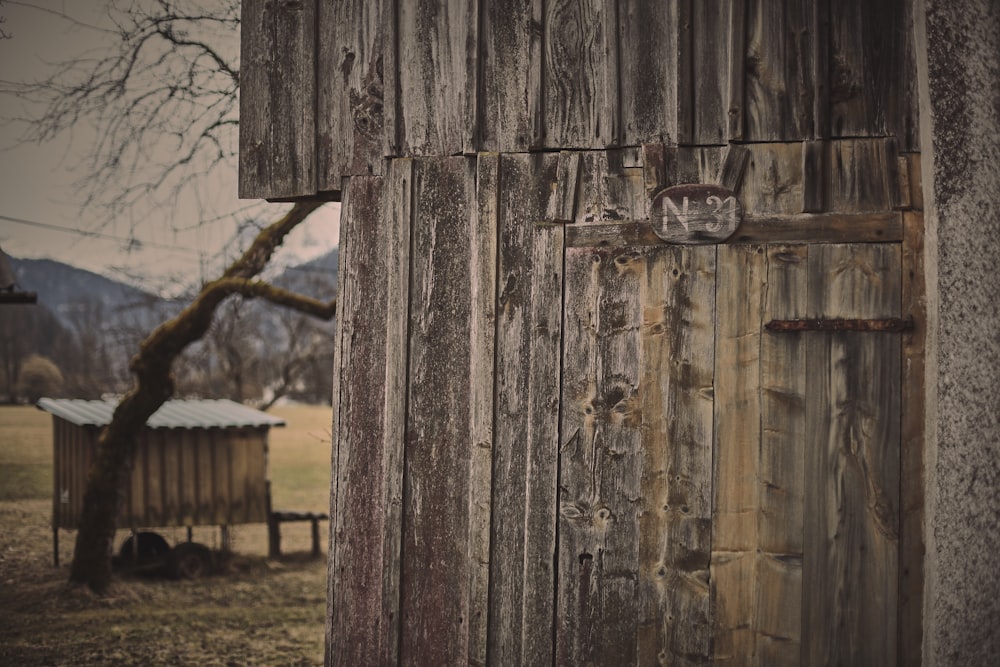 brown wooden fence on green grass field during daytime