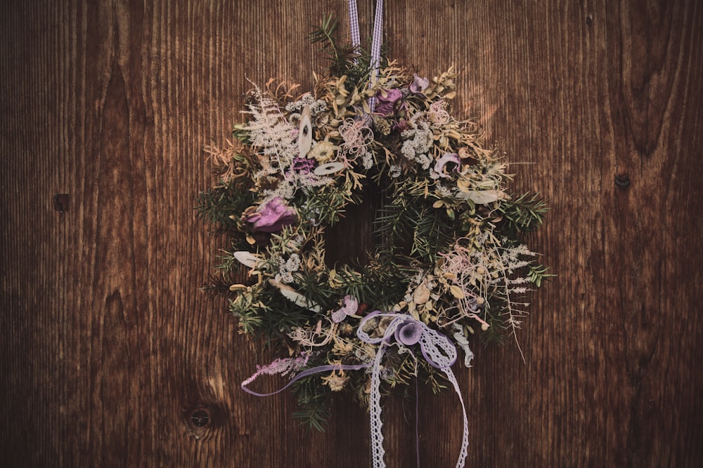 purple and white flowers on brown wooden surface