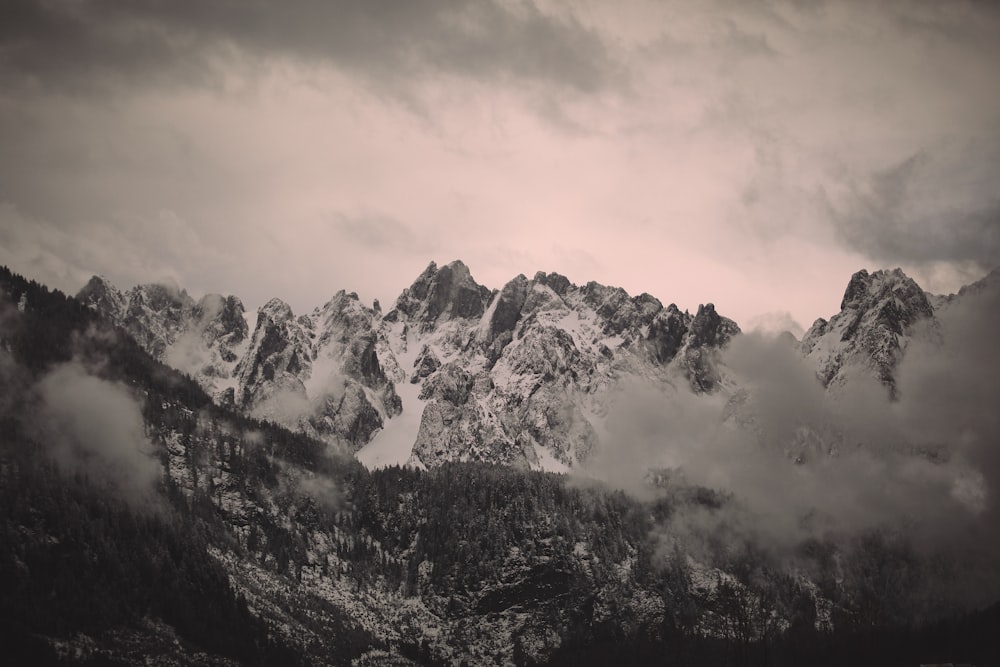 snow covered mountain under cloudy sky during daytime