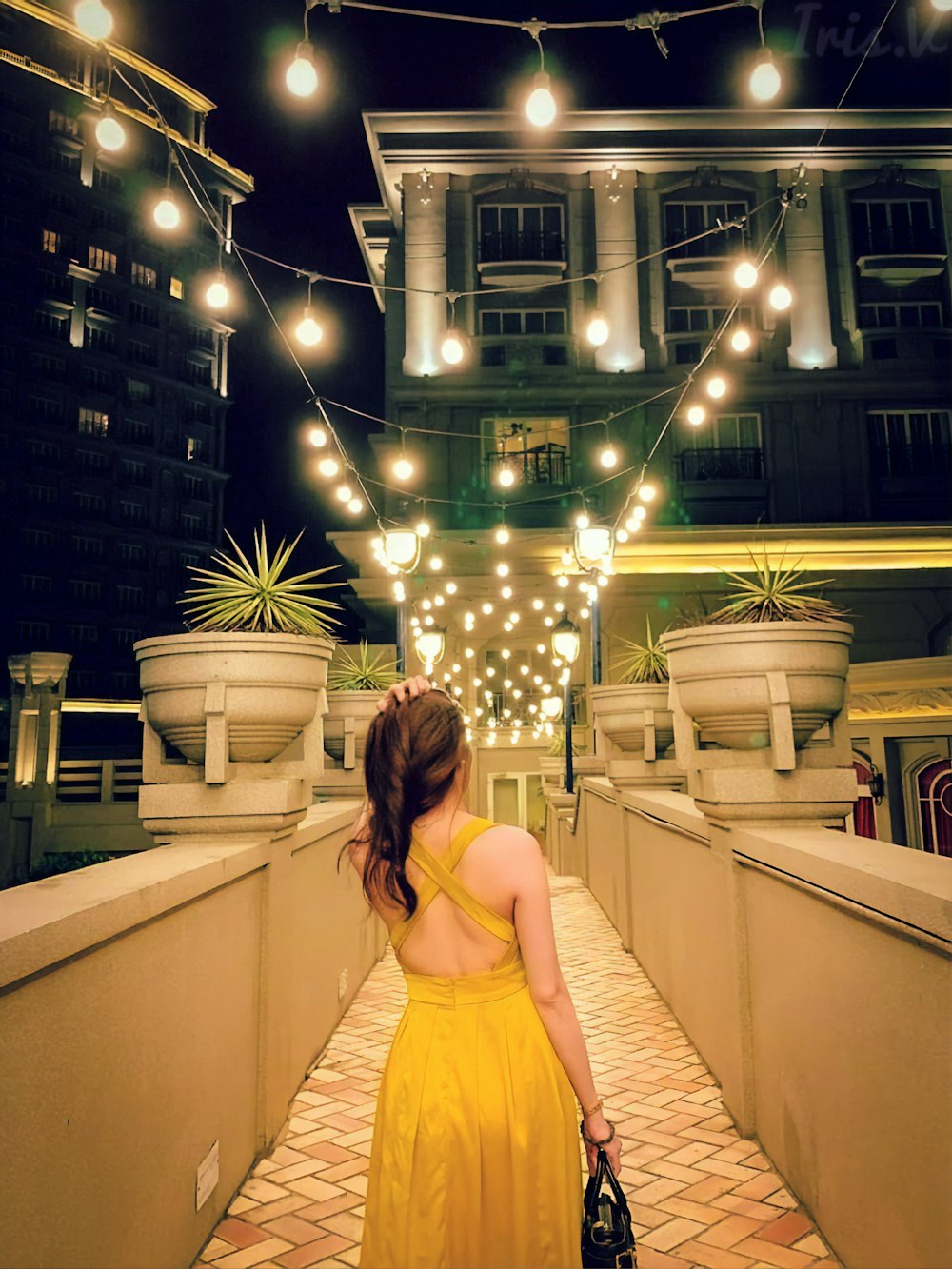 woman in beige dress standing on white staircase