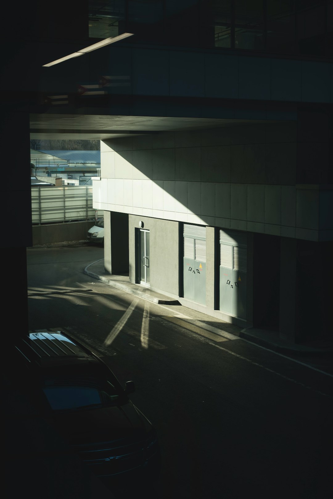 white car parked beside building during daytime