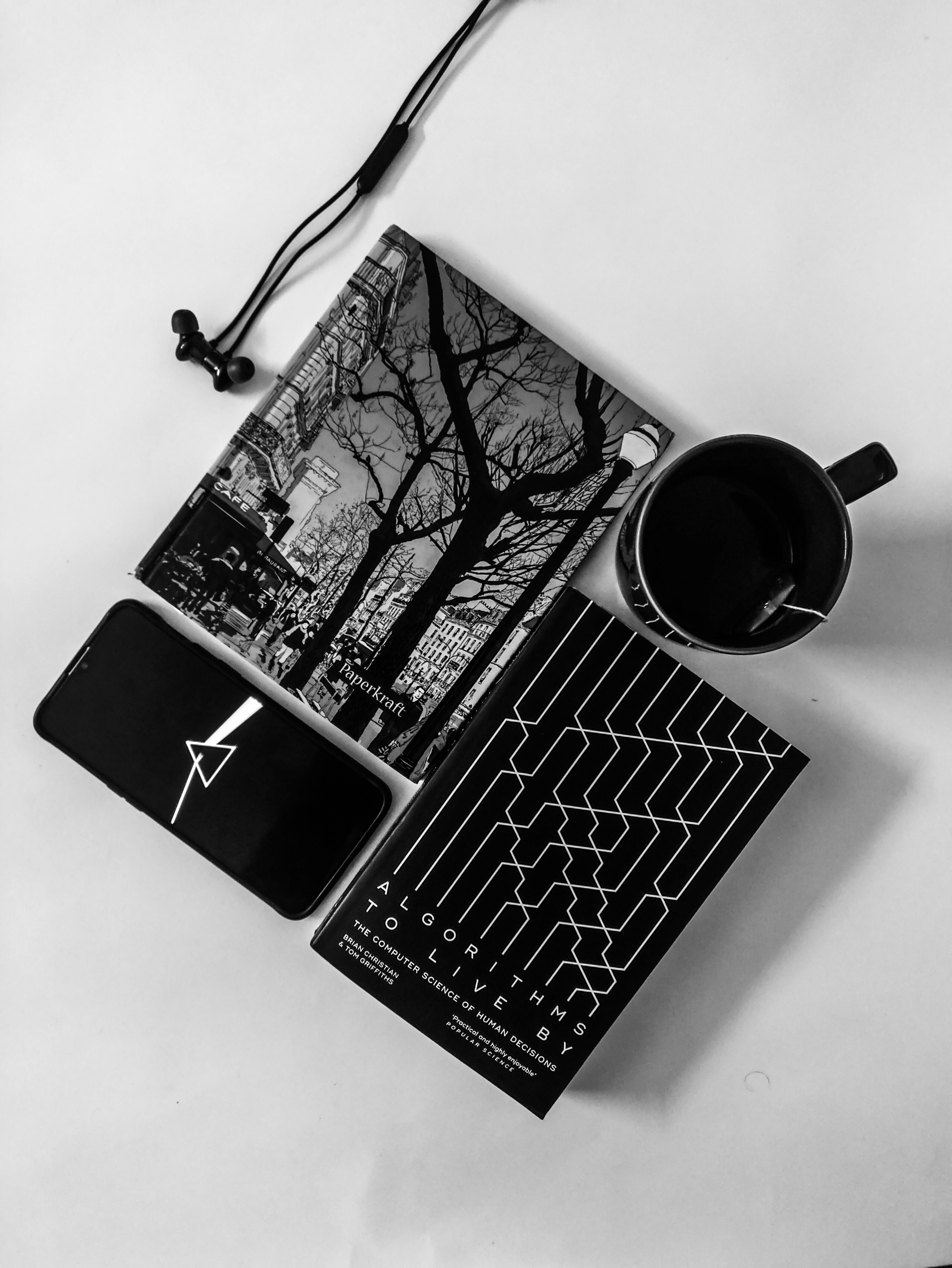 black iphone 7 on macbook pro beside black ceramic mug