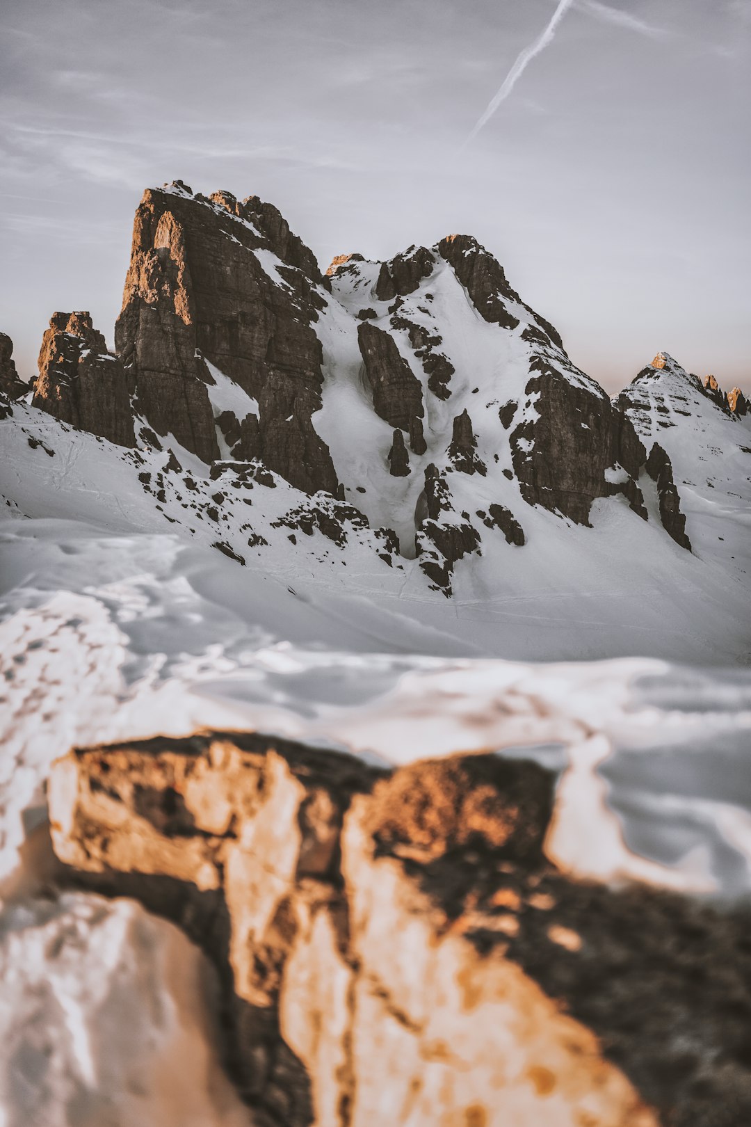 brown rocky mountain covered with snow