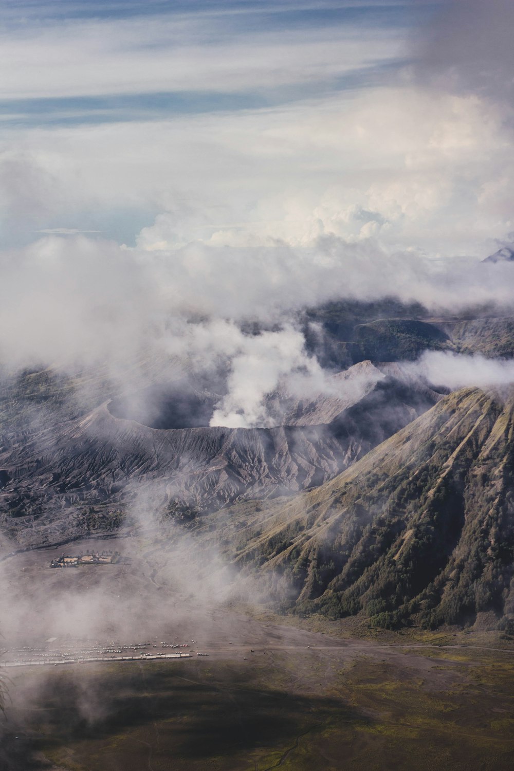 black and white mountain under white clouds