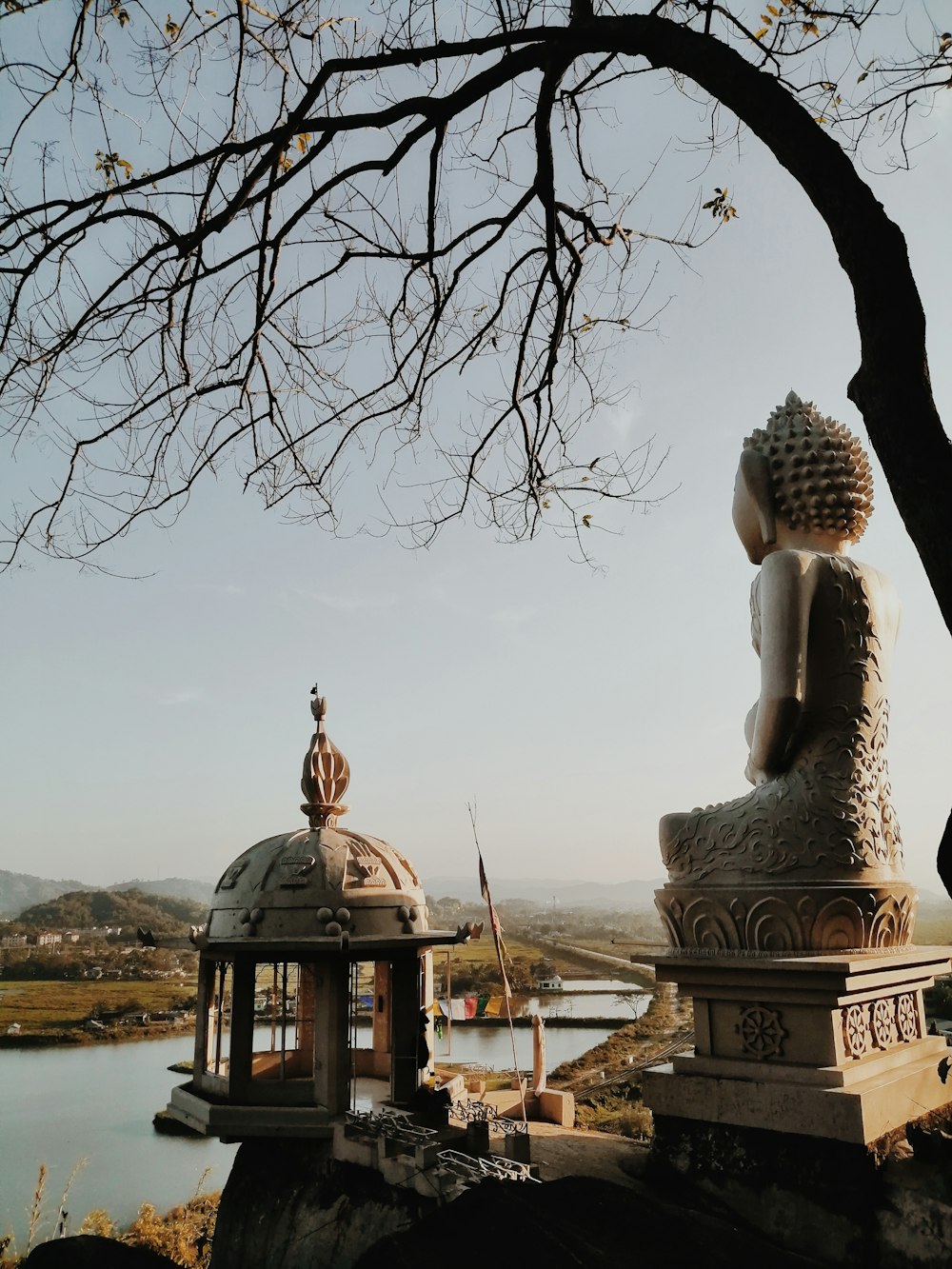 white concrete statue near body of water during daytime