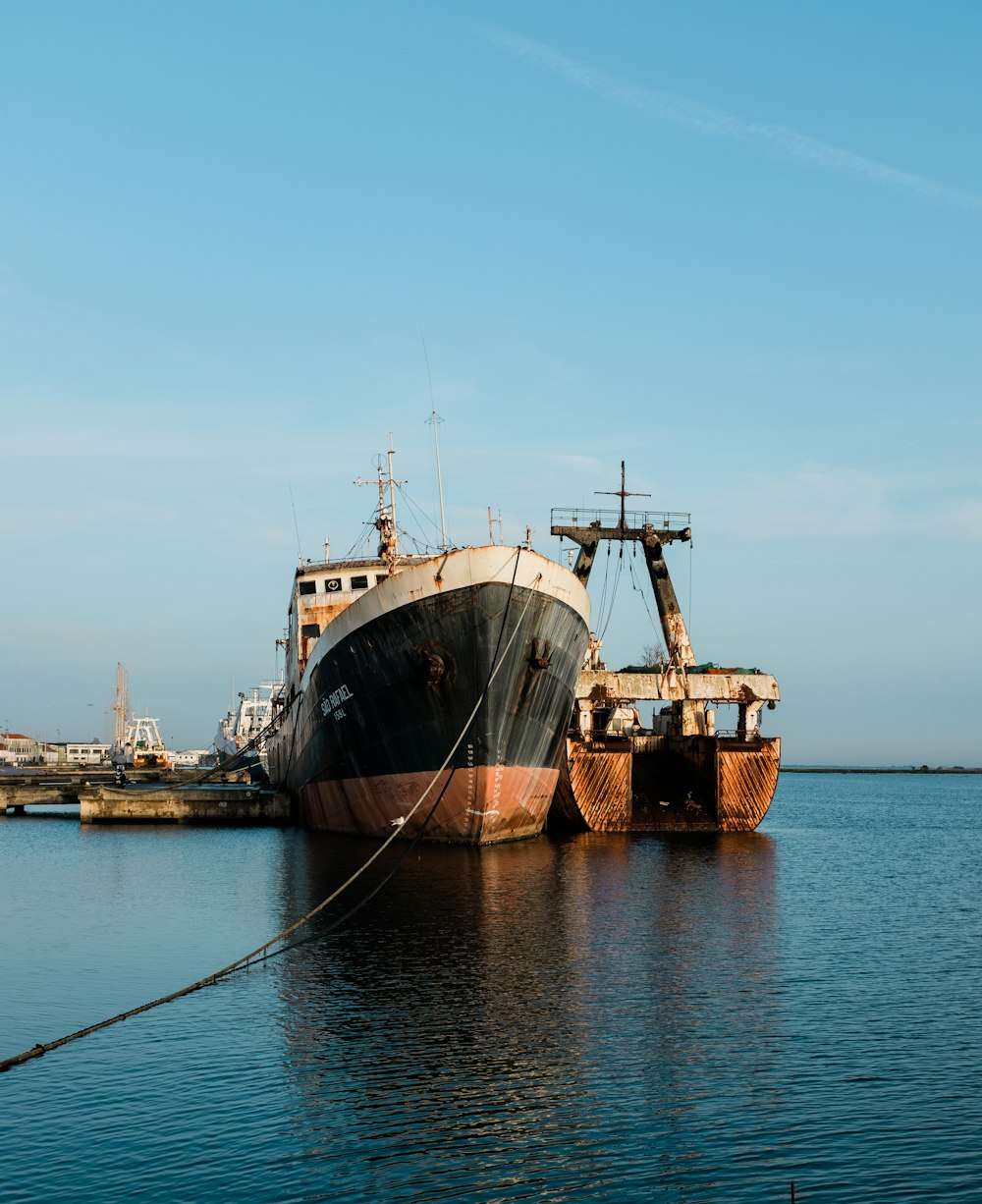 brown and white ship on sea under blue sky during daytime