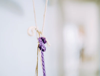 Close-up of colorful love knots tied with delicate ribbons on a wooden table