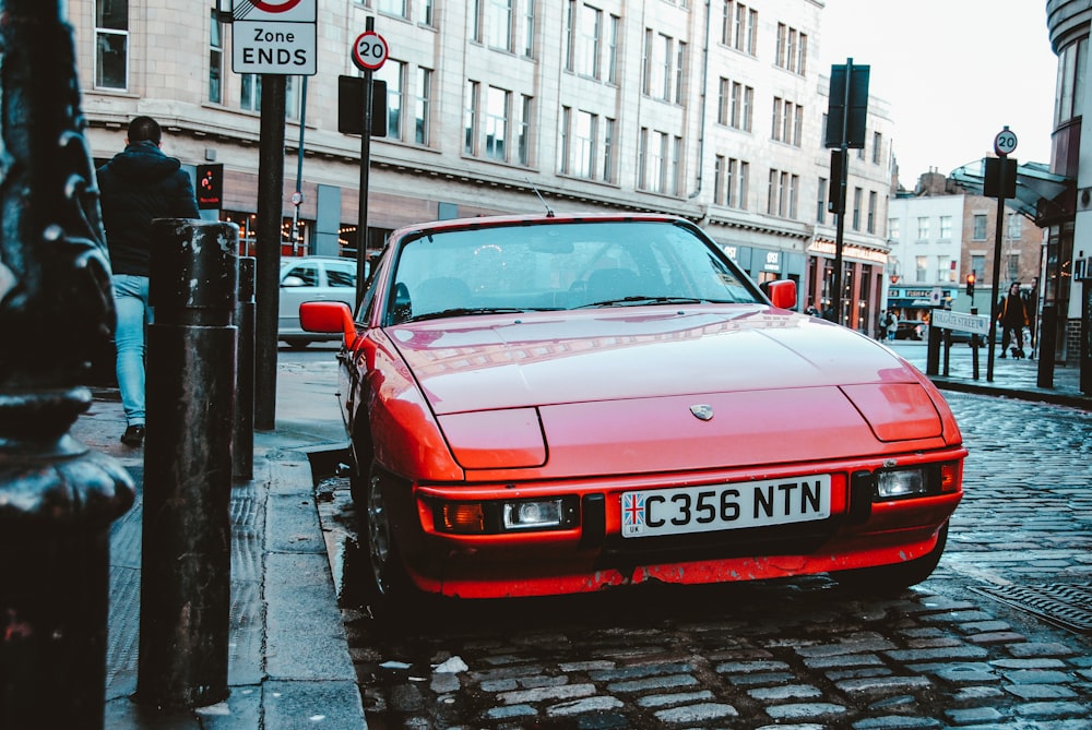 red bmw m 3 parked on sidewalk during daytime