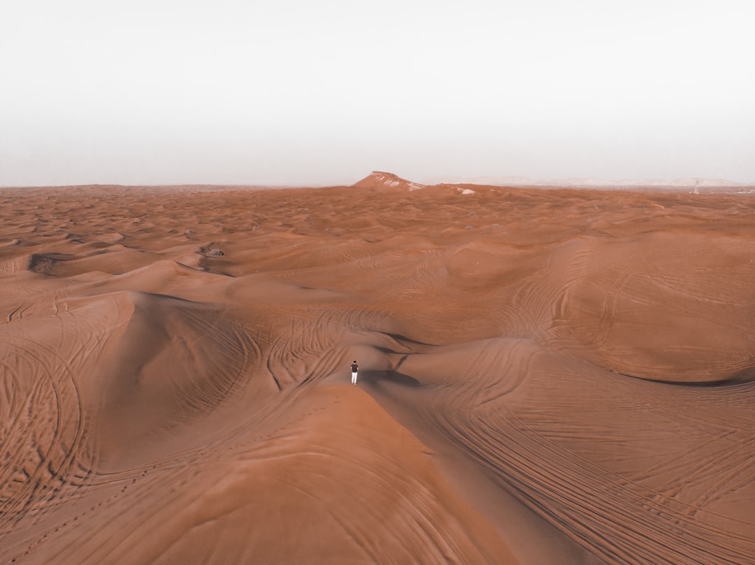 person walking on desert during daytime