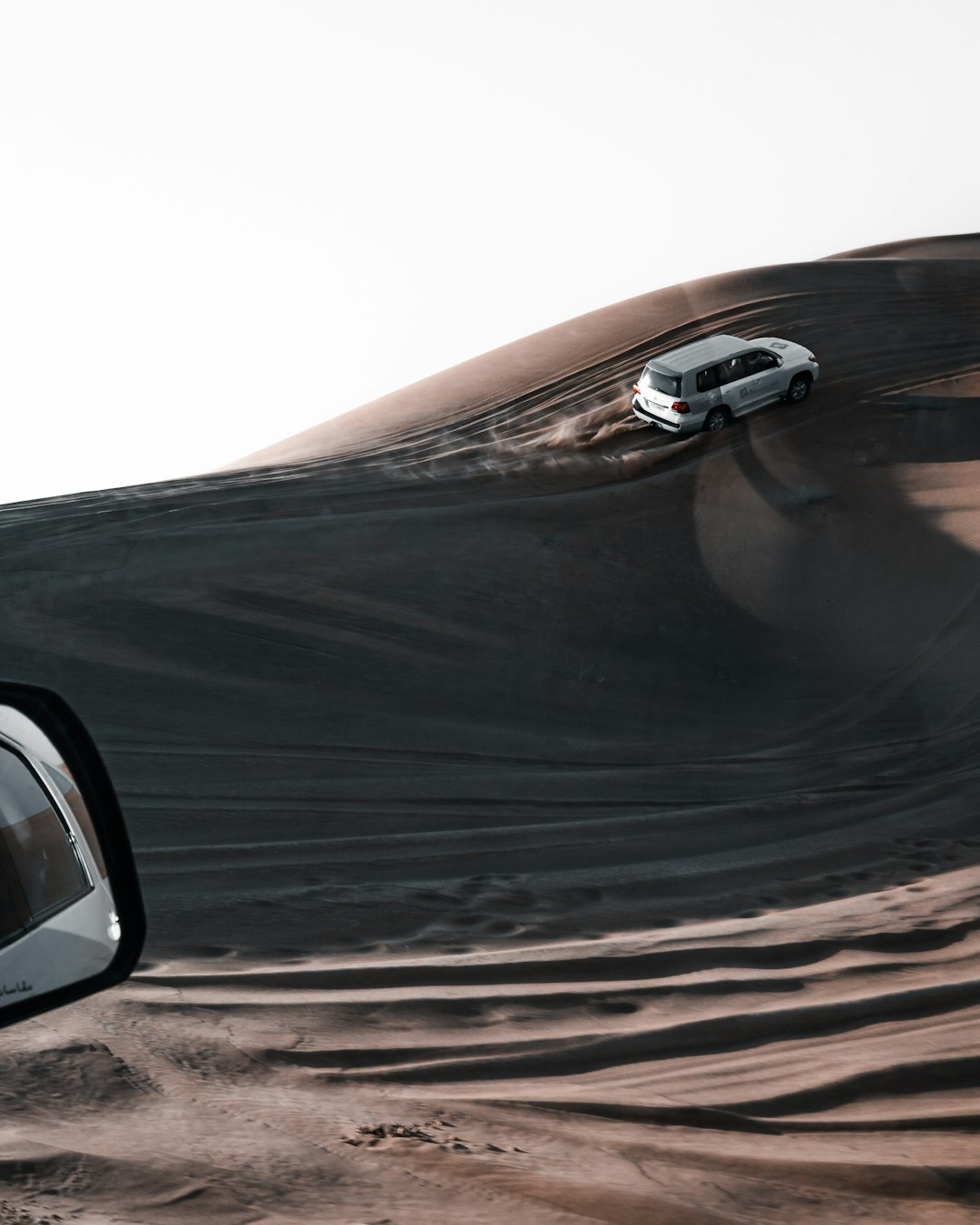 black car on brown sand
