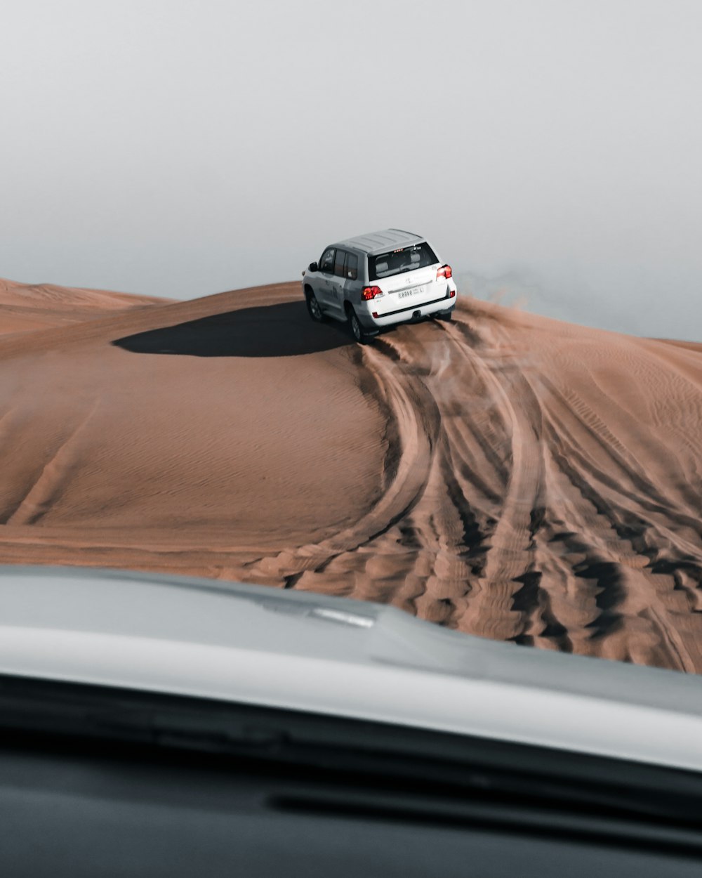 white suv on brown sand