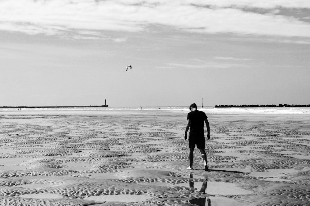 man walking on beach during daytime