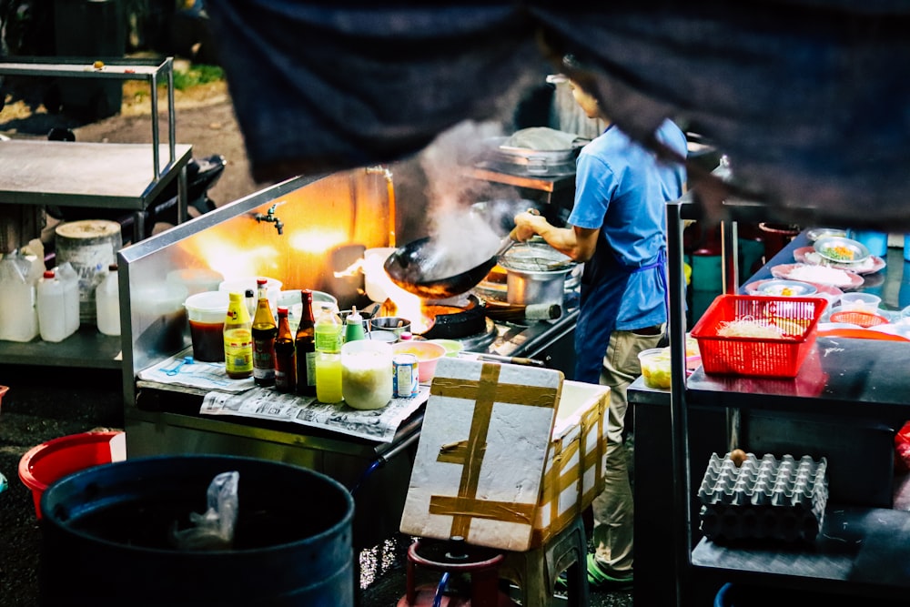 man in white t-shirt cooking