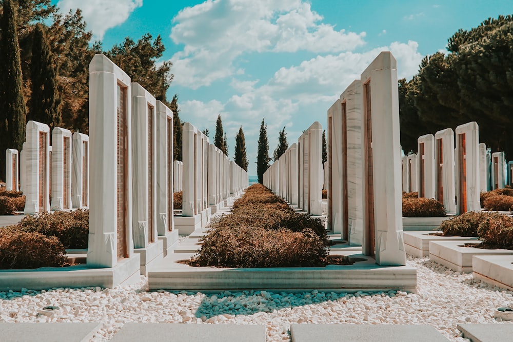 white concrete pillars near swimming pool under blue sky during daytime