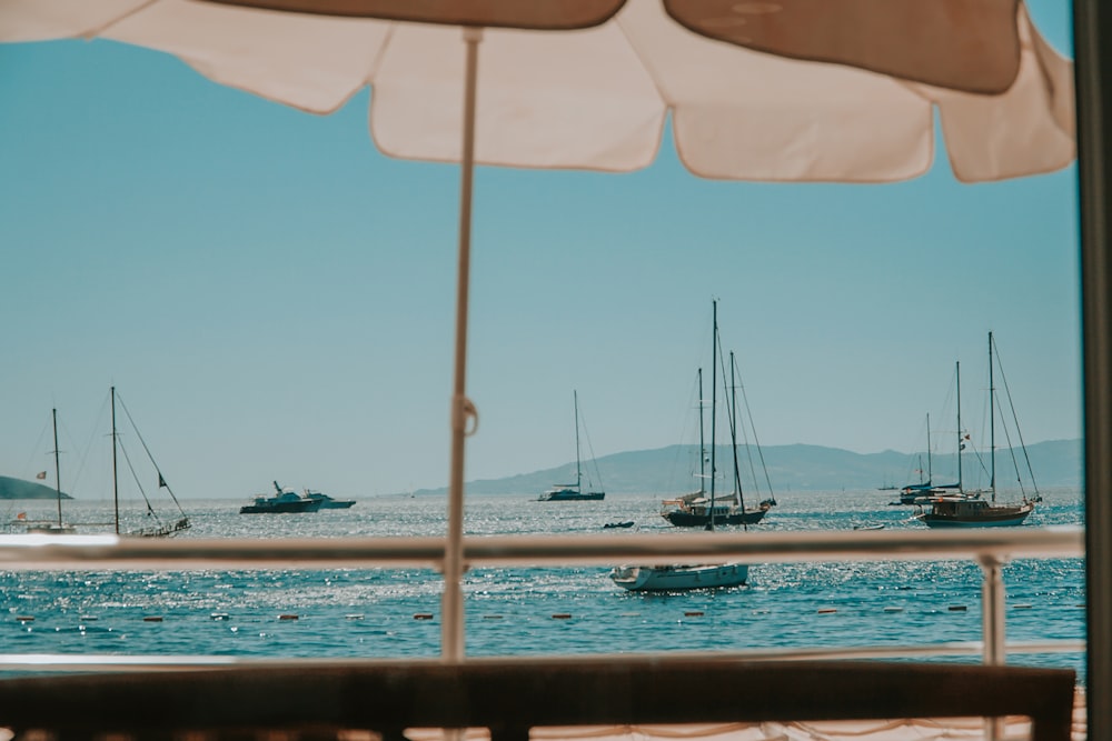 white sail boat on sea during daytime