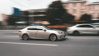 white sedan on road during daytime