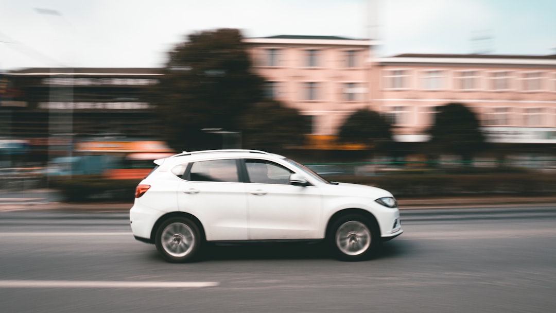 white suv on road during daytime