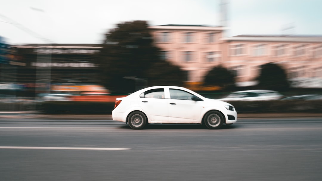 white sedan on road during daytime