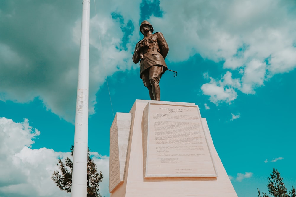 man riding horse statue under blue sky during daytime