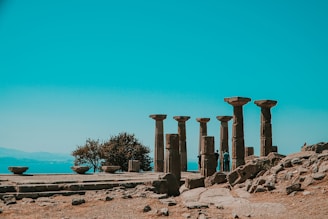 brown concrete pillar near body of water during daytime