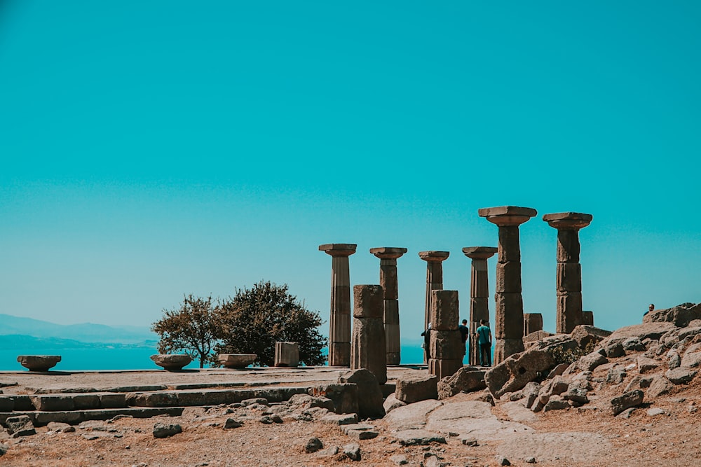 brown concrete pillar near body of water during daytime