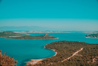 A serene landscape of the Andaman Islands with turquoise waters and lush greenery.