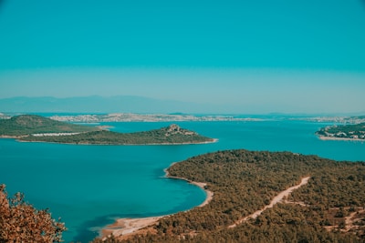 A serene landscape of the Andaman Islands with turquoise waters and lush greenery.