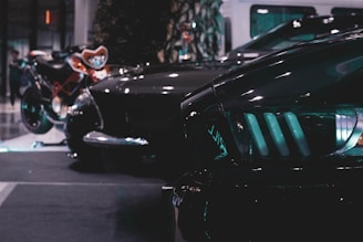 A dark-themed, stylish display of various car lamps and parts arranged neatly with subtle lighting highlighting their details.