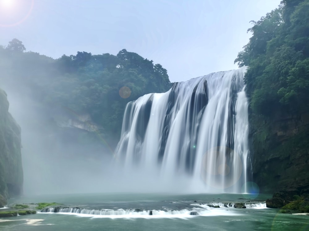 waterfalls under white sky during daytime