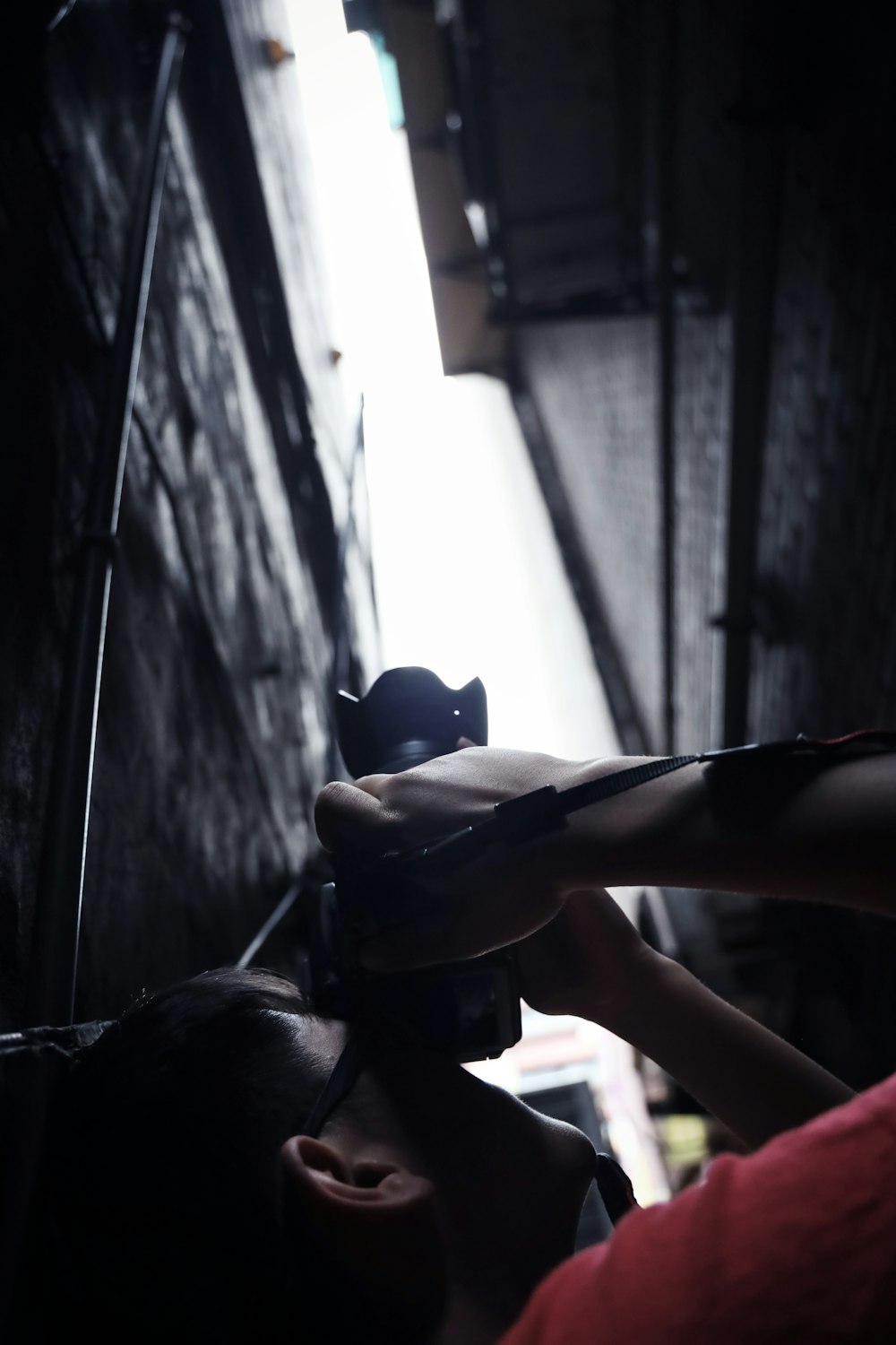 person holding black and orange plastic toy gun