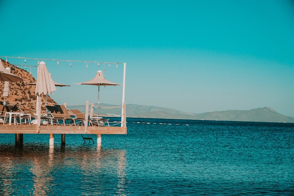 brown wooden dock on blue sea under blue sky during daytime