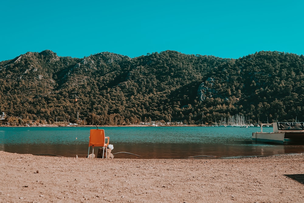 person sitting on white and brown chair on beach during daytime