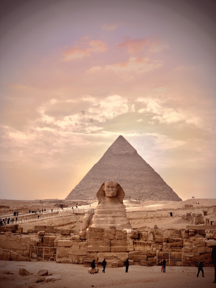 A scenic view of the Pyramids of Giza under a clear blue sky.