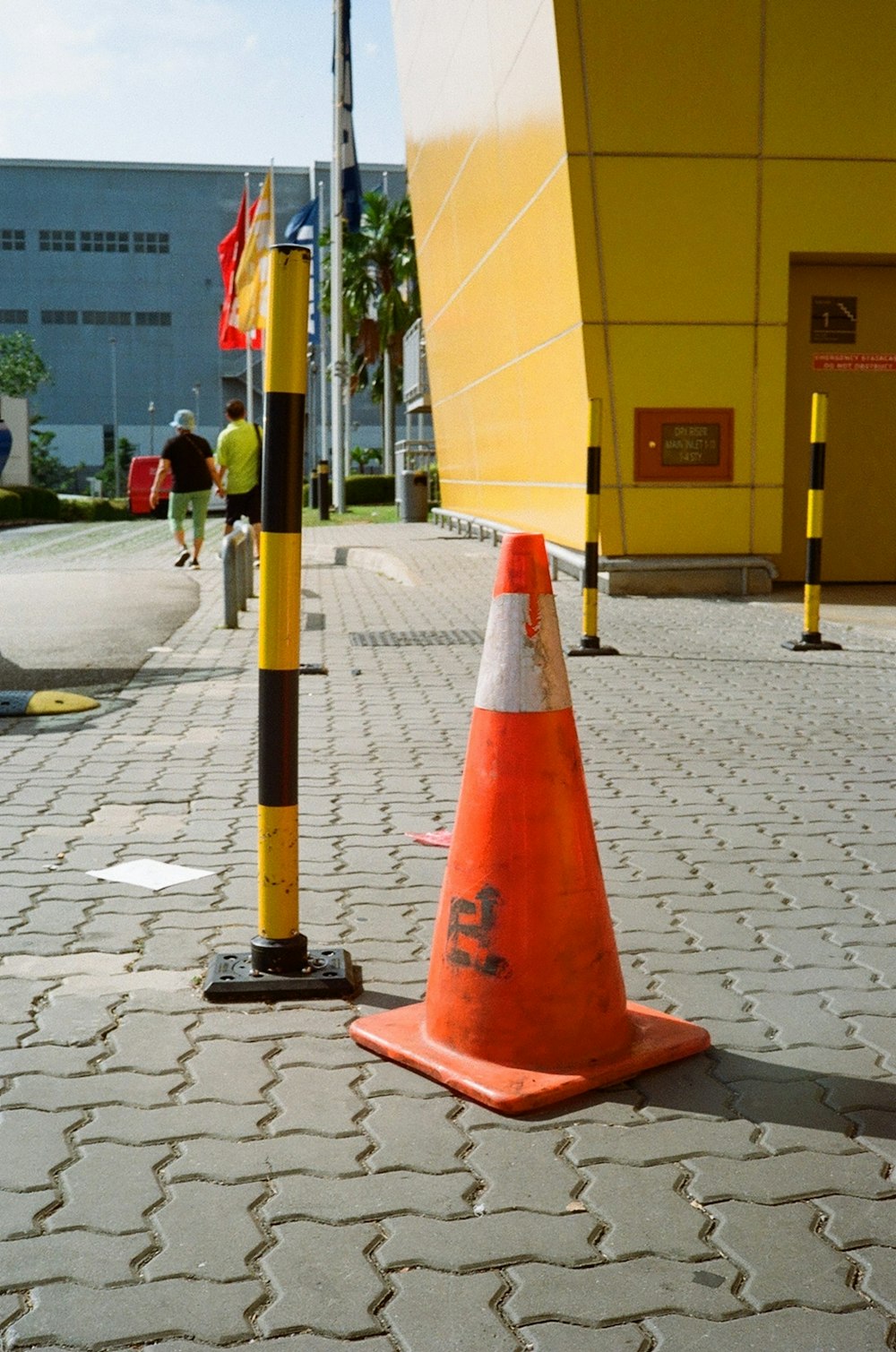 red and black traffic cone on gray concrete pavement